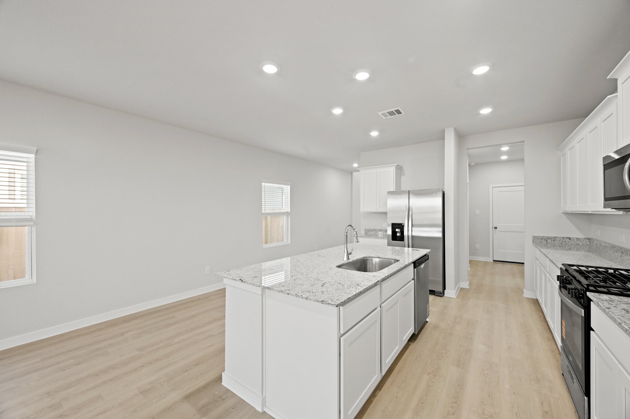 A kitchen with white cabinets.