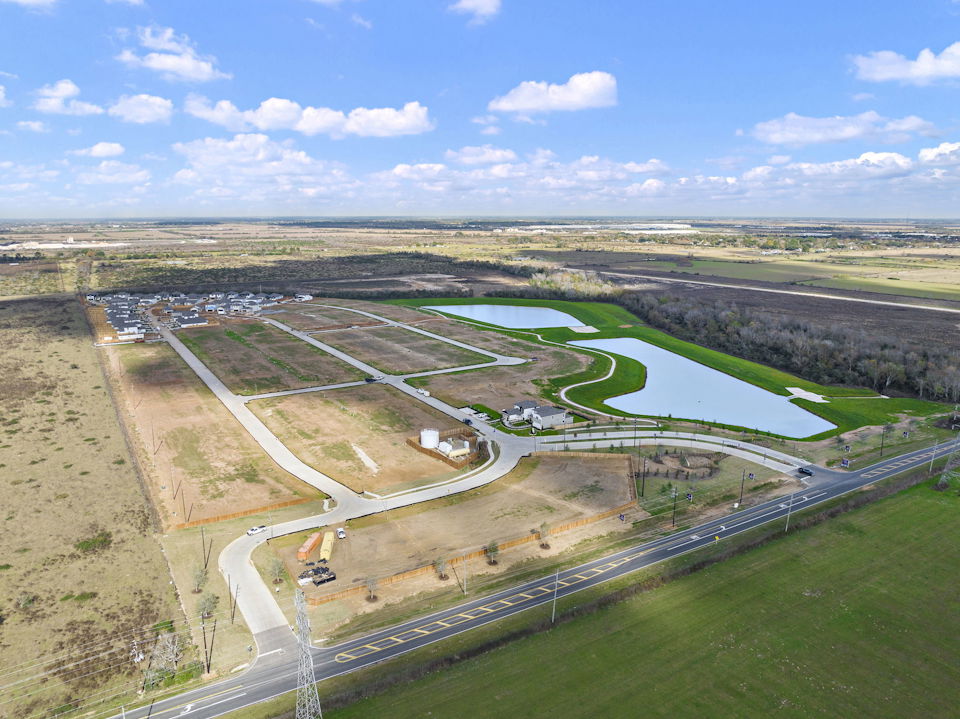 A high angle view of a road with Prairie Queen Recreation Area in the background.