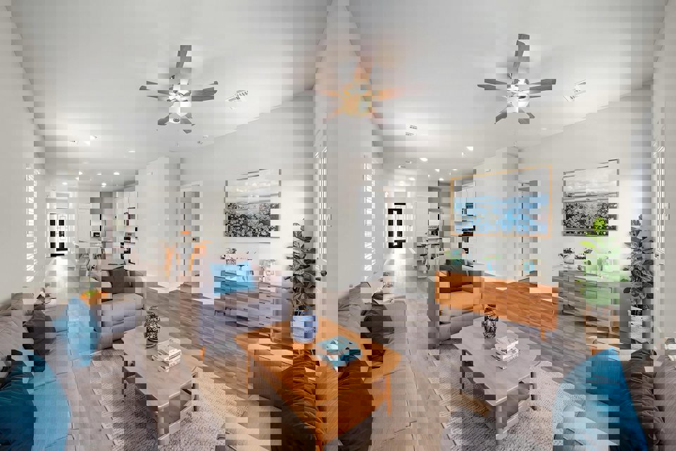 A living room with a ceiling fan.