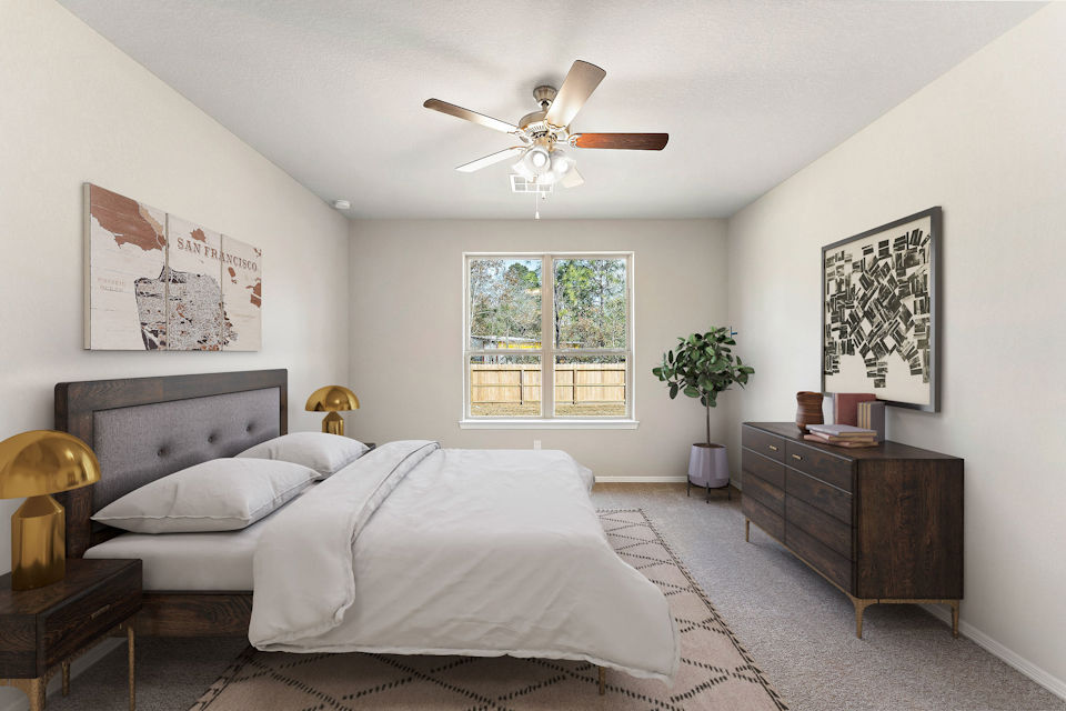 A bedroom with a bed and a fan.