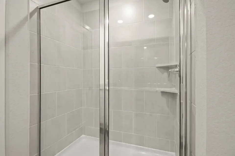 A shower with a glass door.