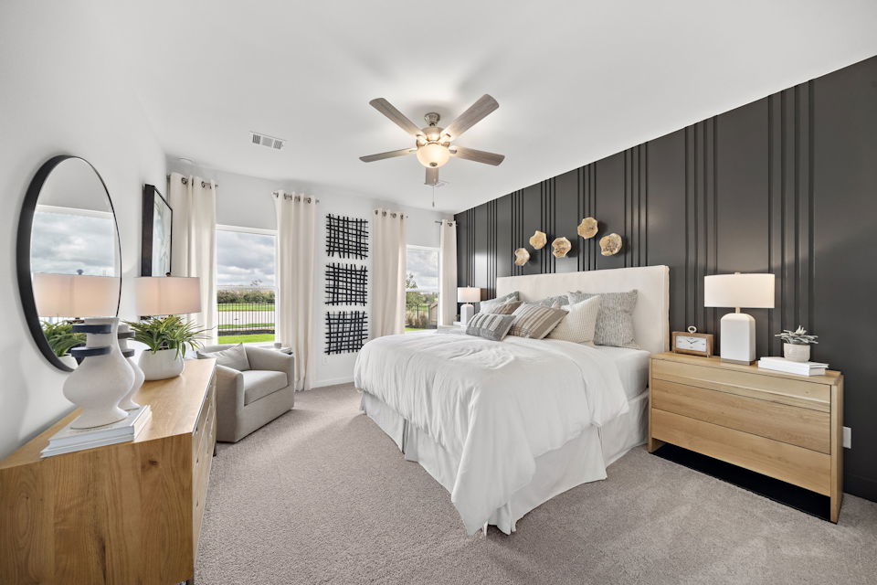 A bedroom with a large bed and a large fan.