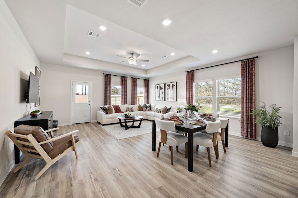 A large living room with a large dining table and chairs.