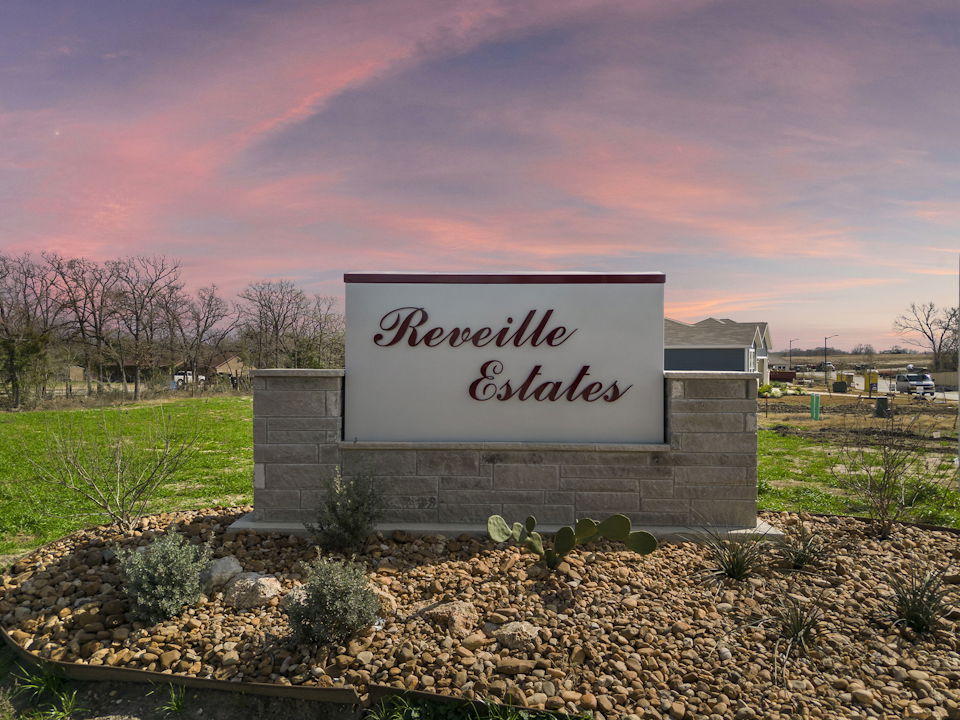A sign on a stone wall.