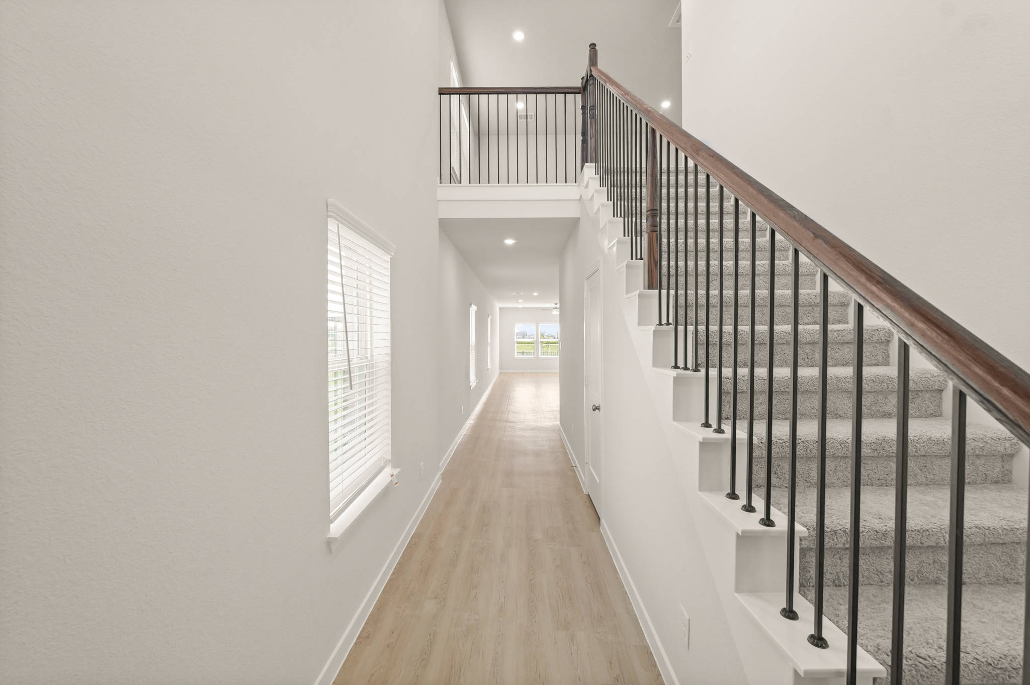 A long hallway with white walls.