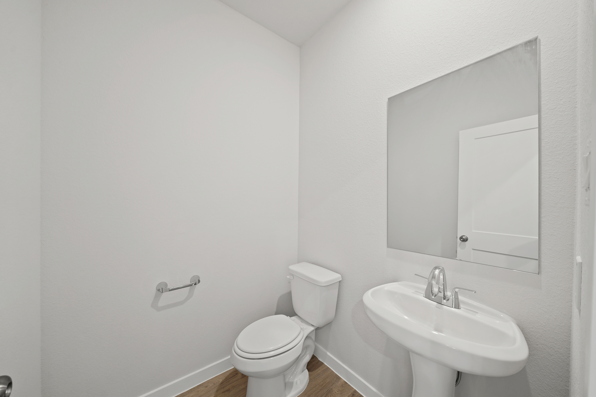 A bathroom with a toilet and sink.