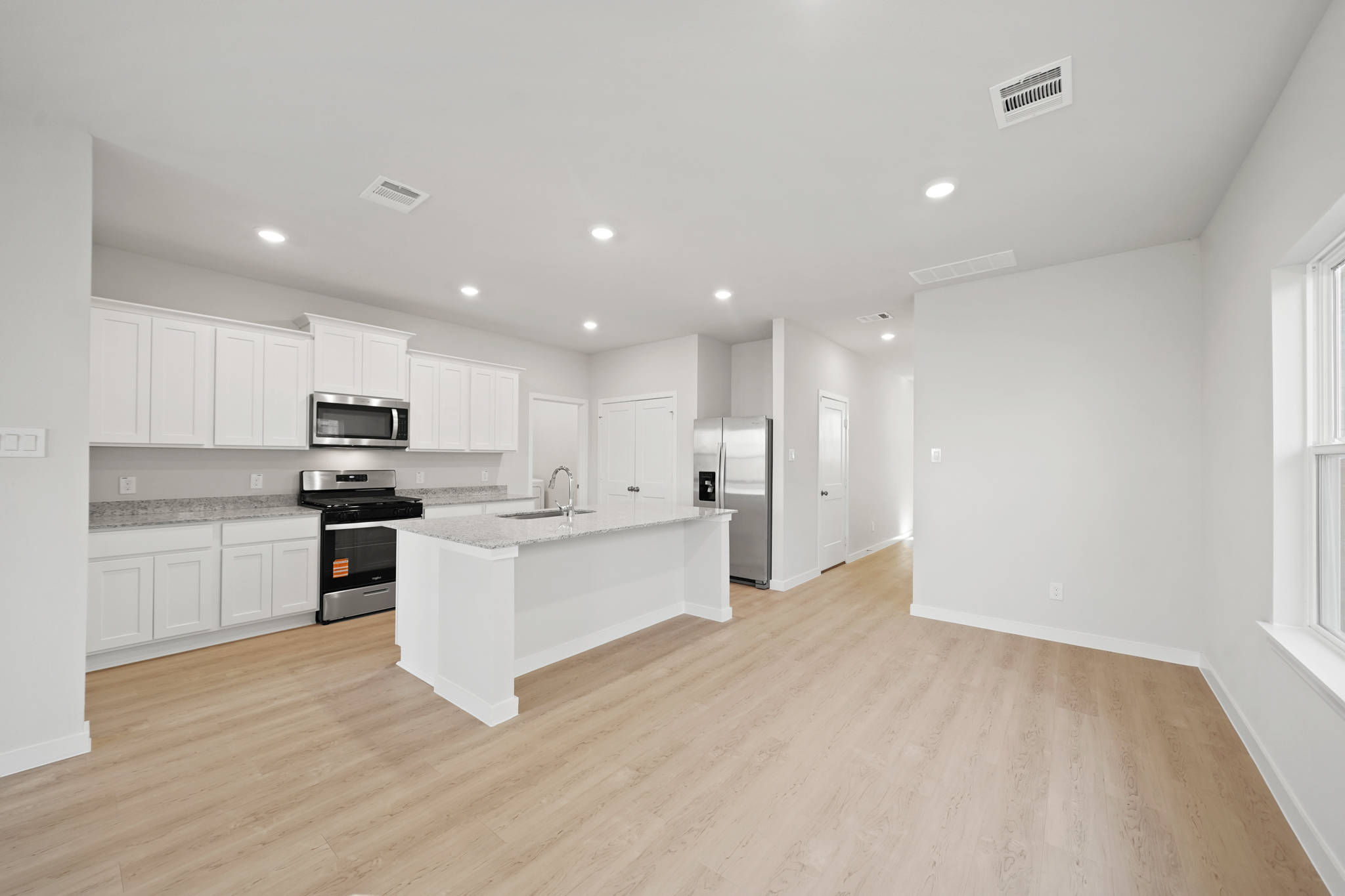 A kitchen with white cabinets.