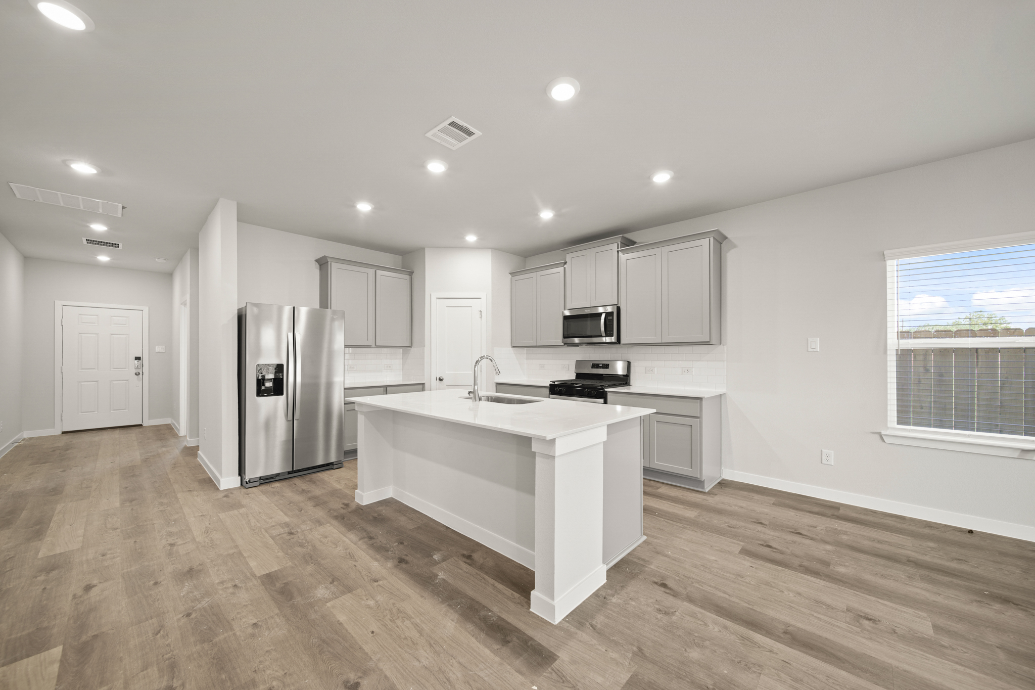 A kitchen with white cabinets.