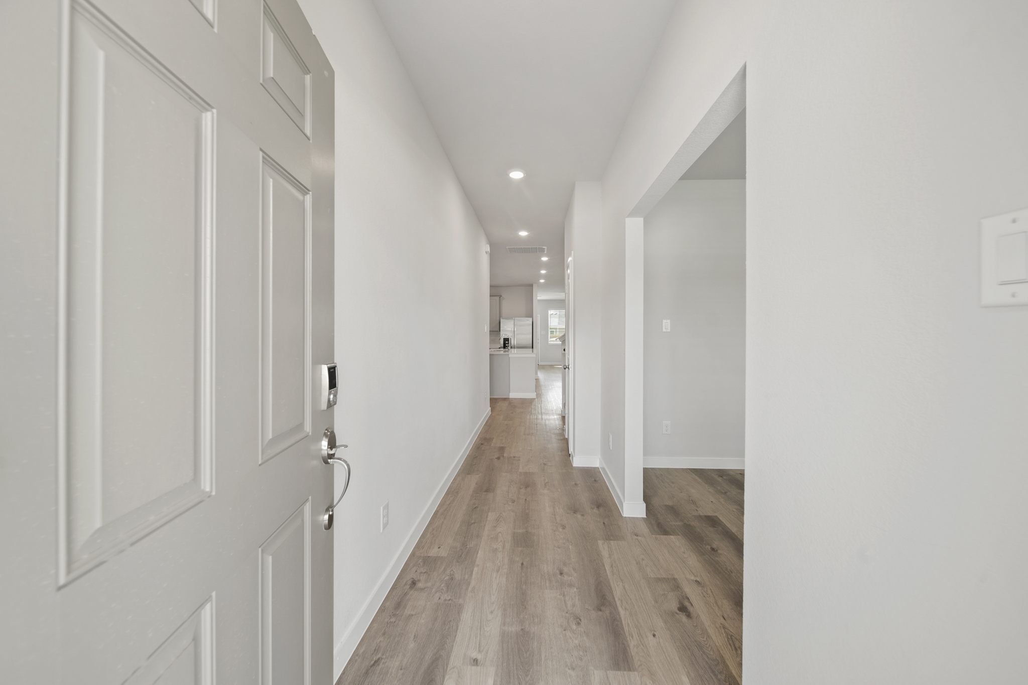 A hallway with white doors.