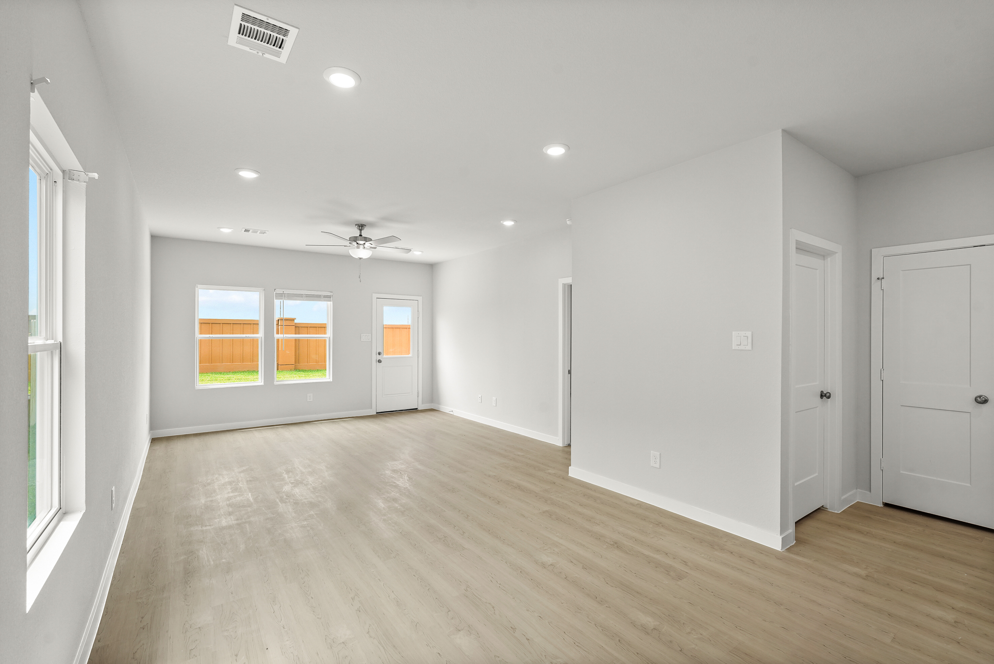 A room with white walls and a wood floor.