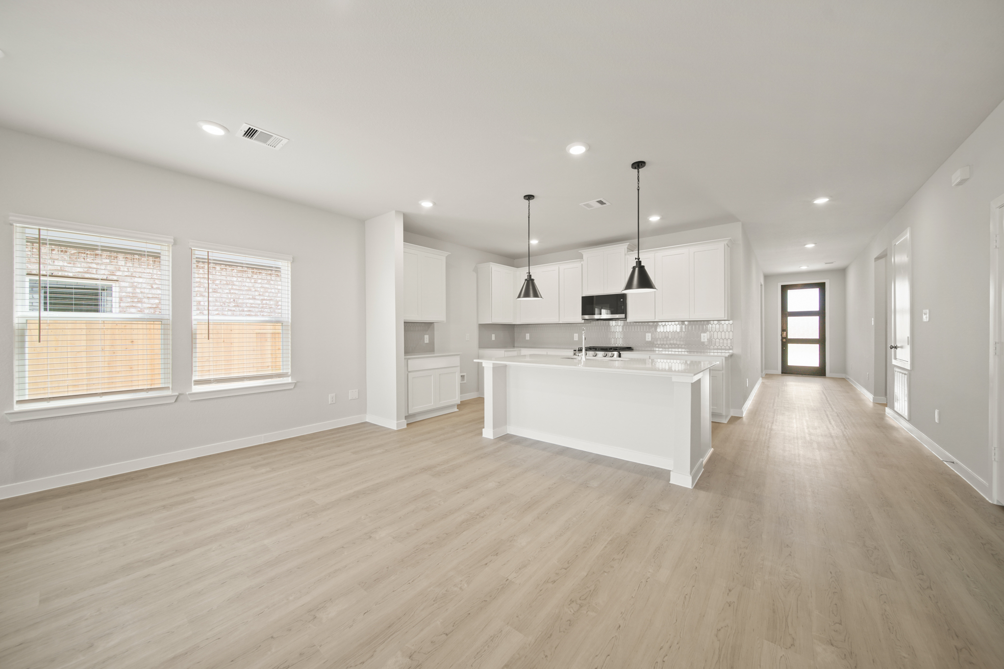 A large kitchen with white cabinets.