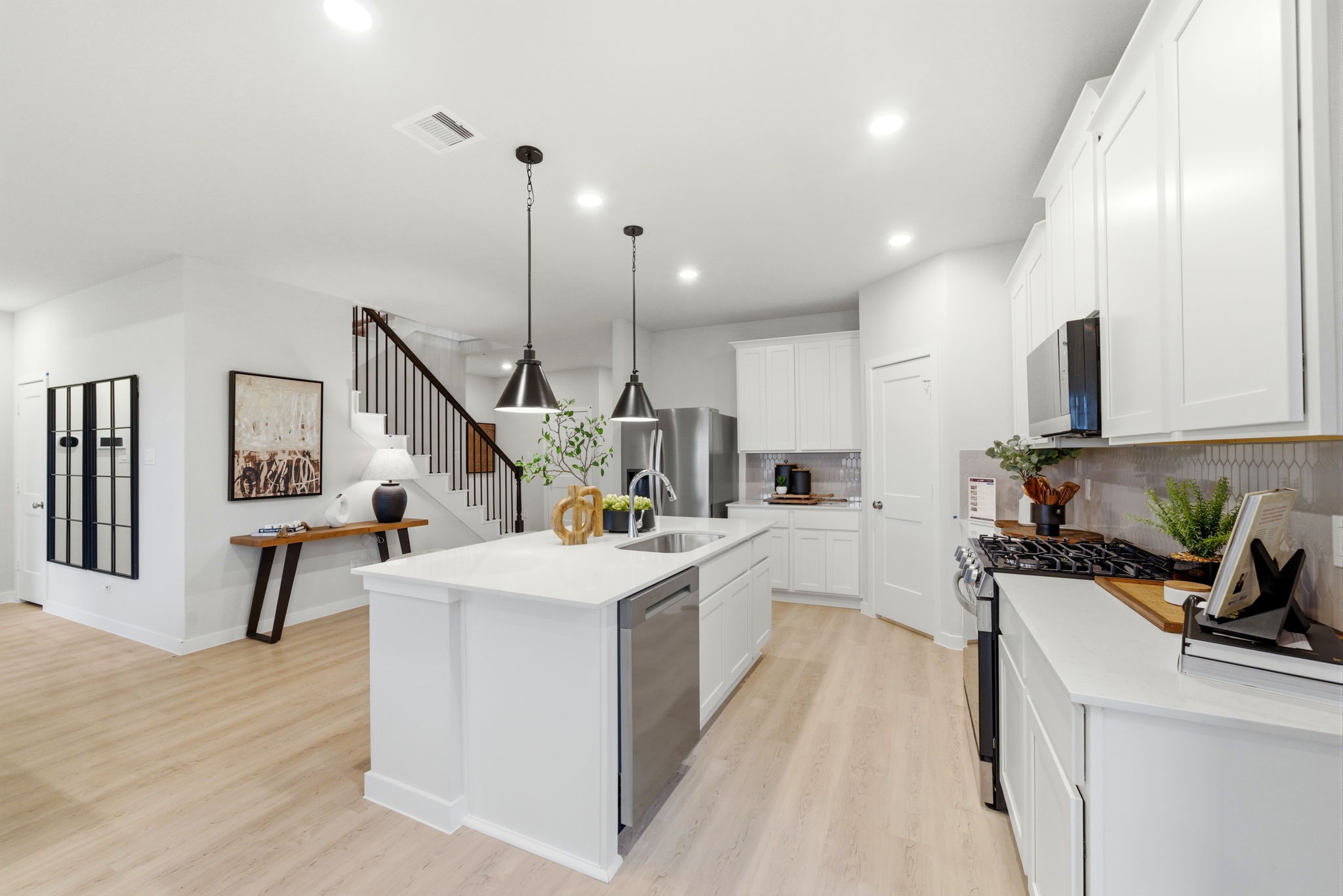 A kitchen with white cabinets.