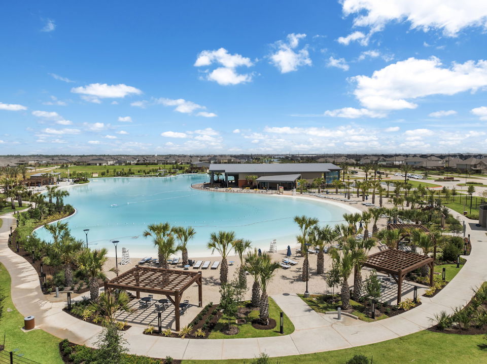 A pool with a building and trees around it.
