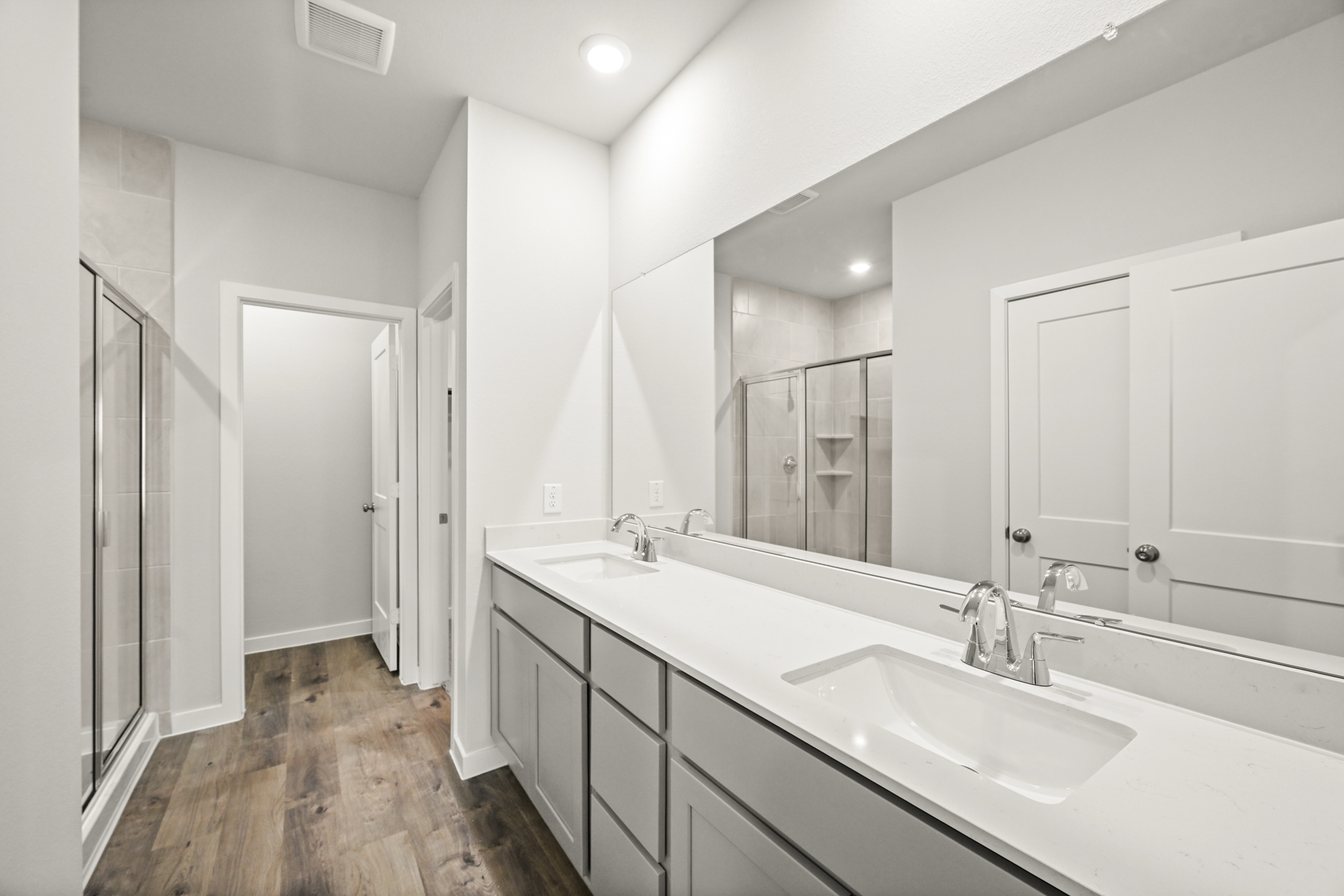 A bathroom with a large mirror.