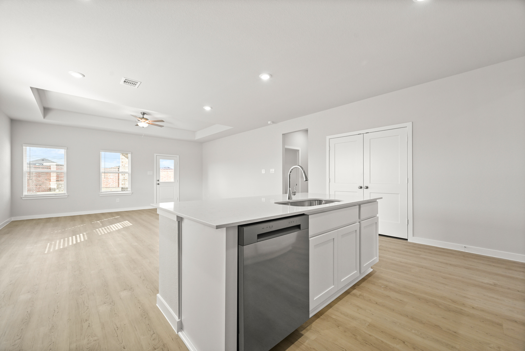 A kitchen with white cabinets.