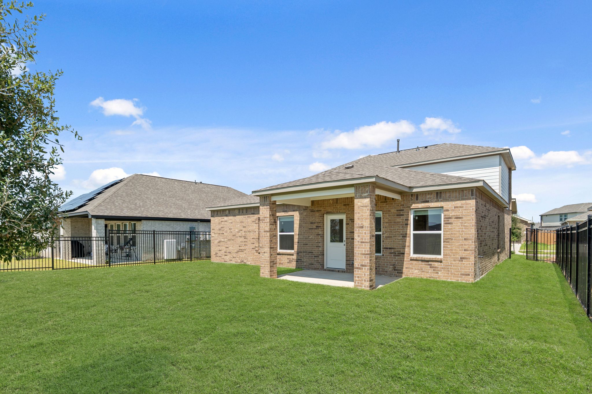 A brick house with a fence.