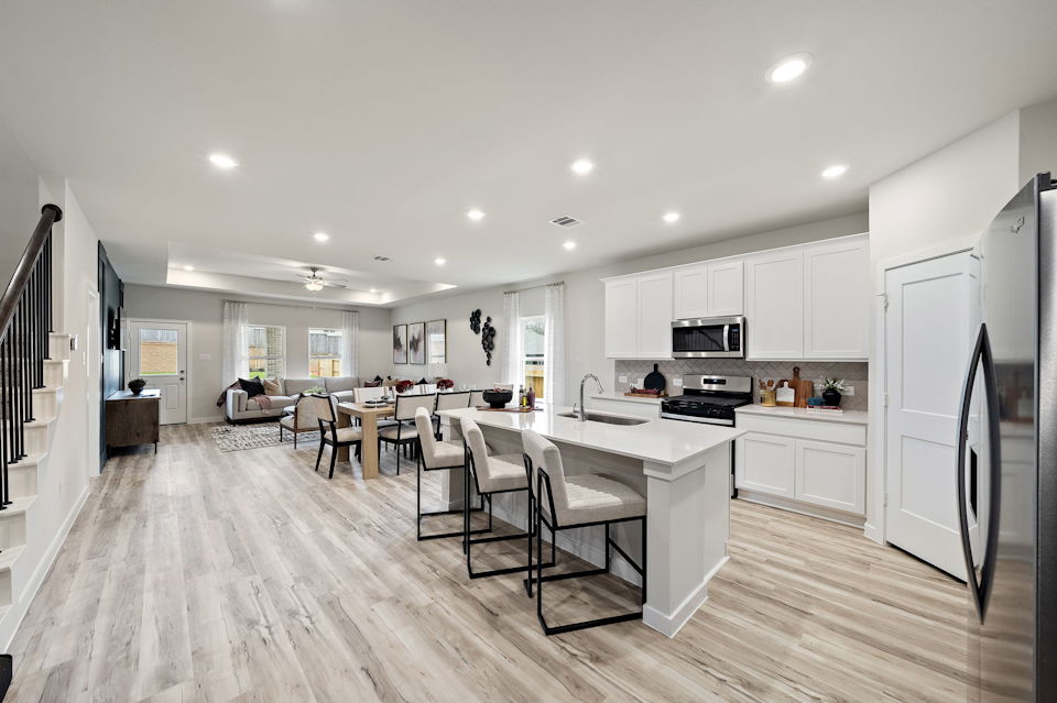 A kitchen with white cabinets.