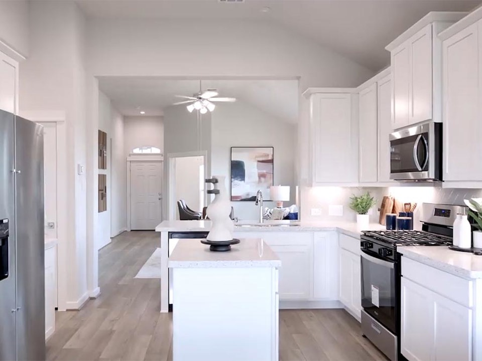 A kitchen with white cabinets.
