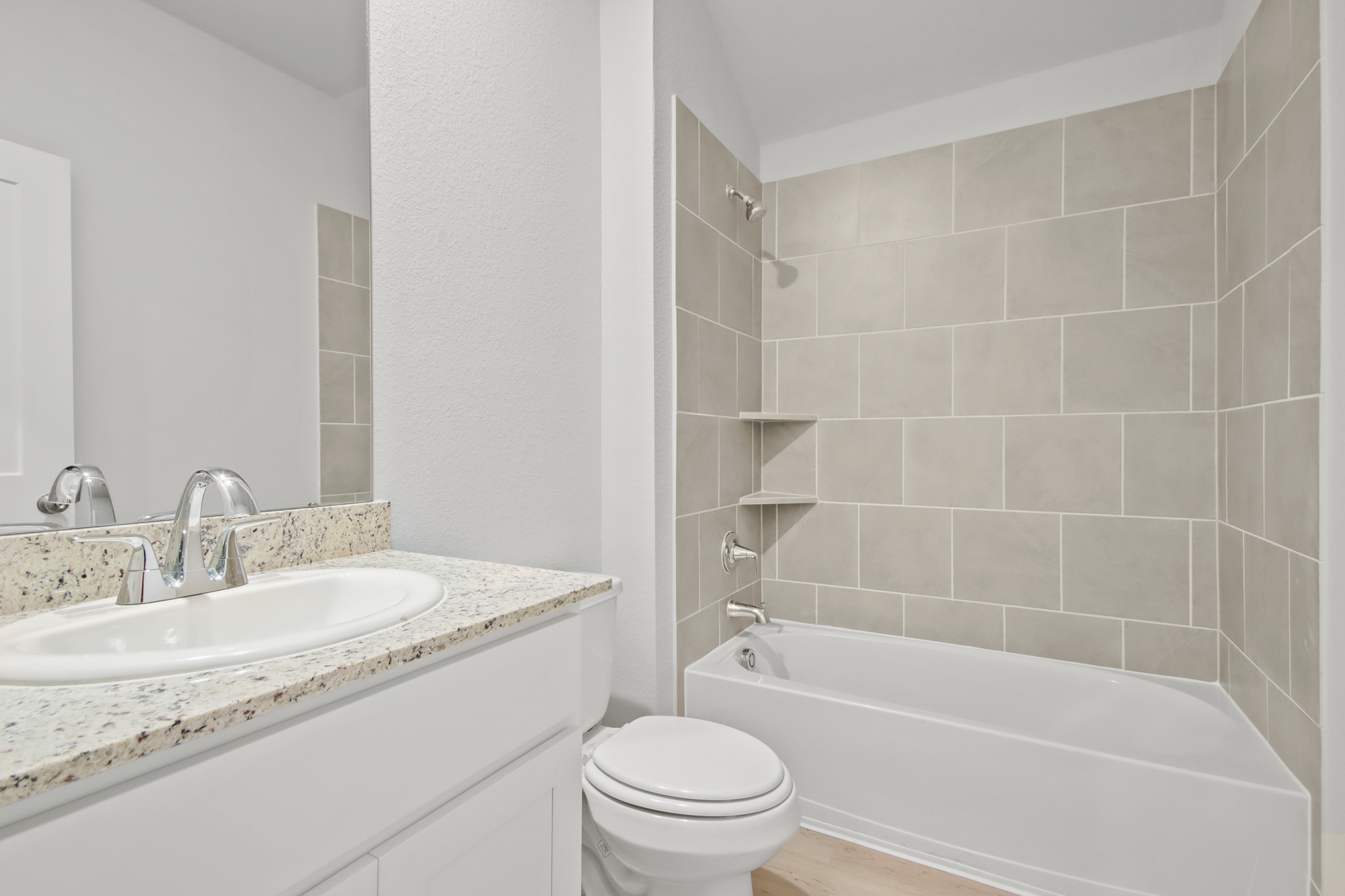 A bathroom with a tub sink and toilet.