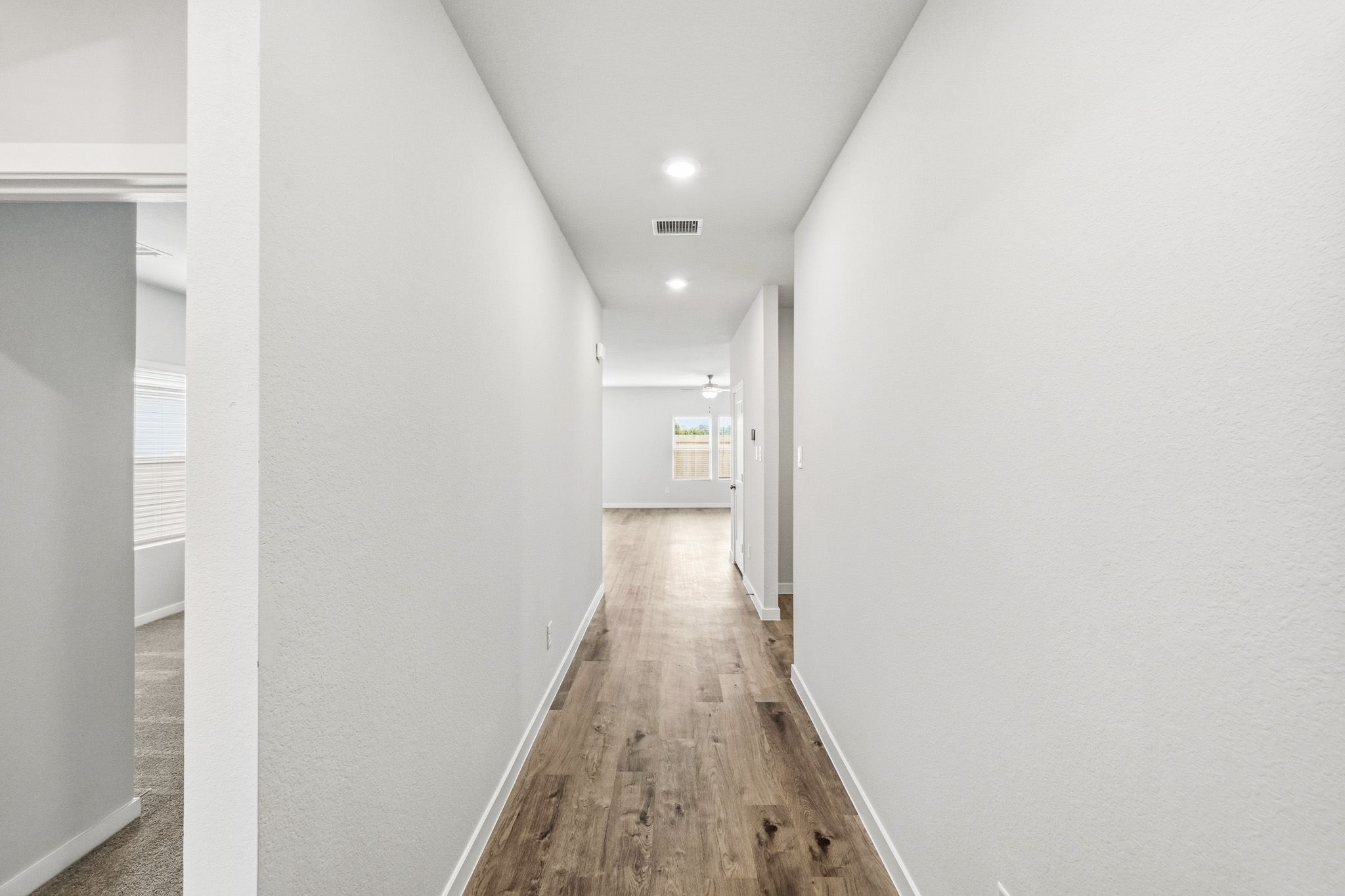 A long hallway with white walls.