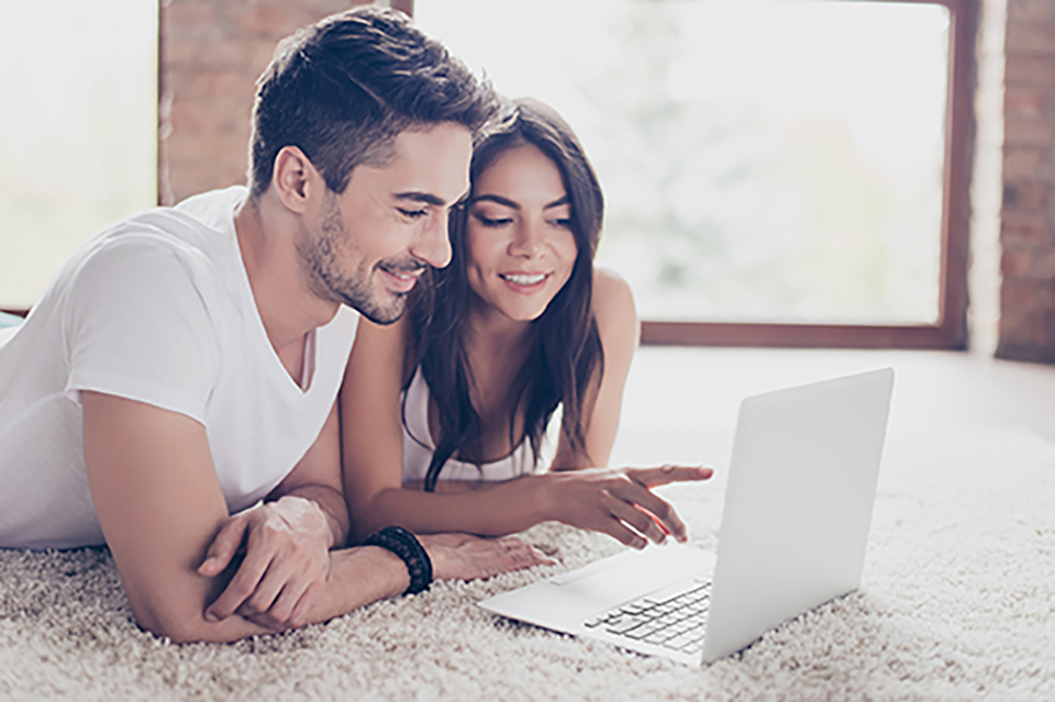 A man and a woman looking at a laptop.