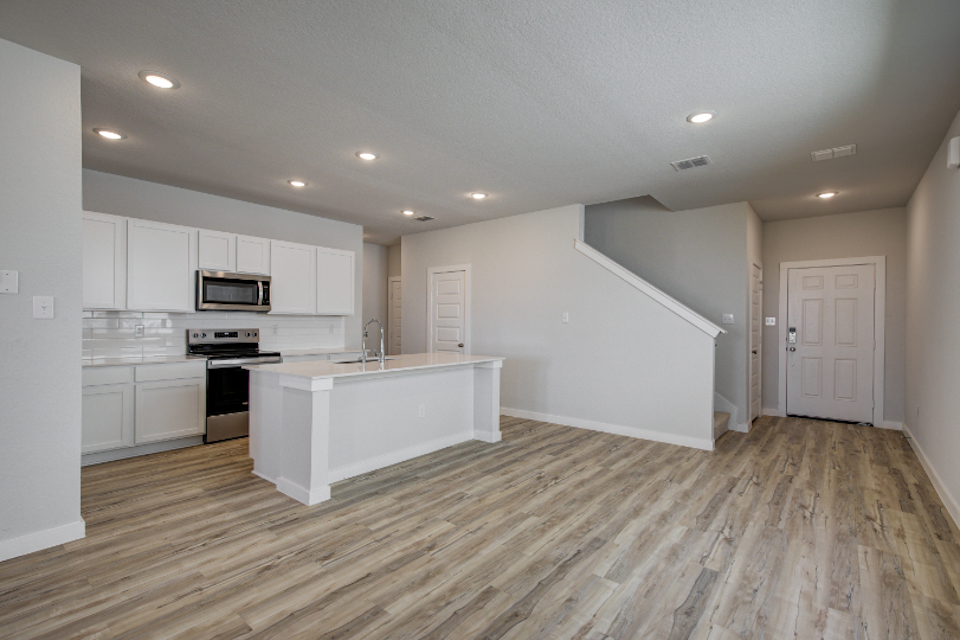 A kitchen with white cabinets.