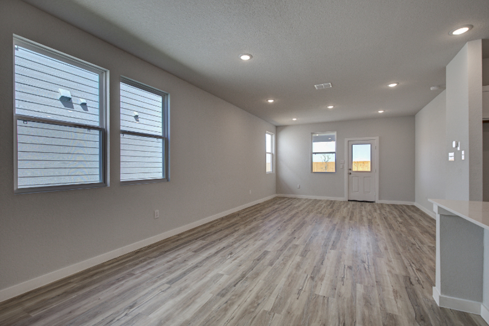 A room with a wood floor and white walls.