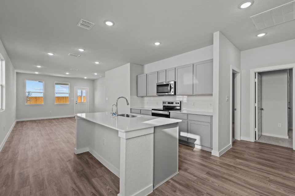 A kitchen with white cabinets.