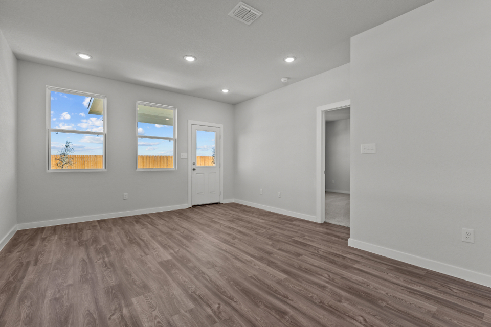 A room with a wood floor and white walls.