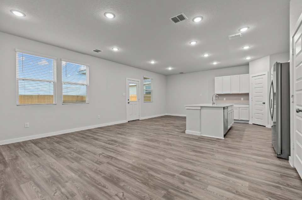 A kitchen with white cabinets.