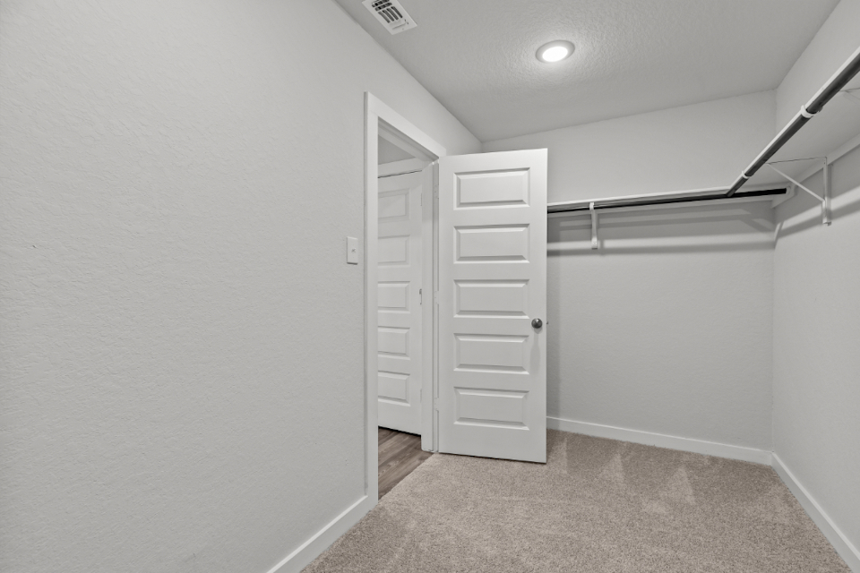 A hallway with white doors.