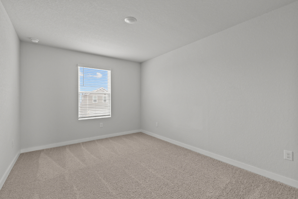 A room with a white wall and a blue and white striped wall.
