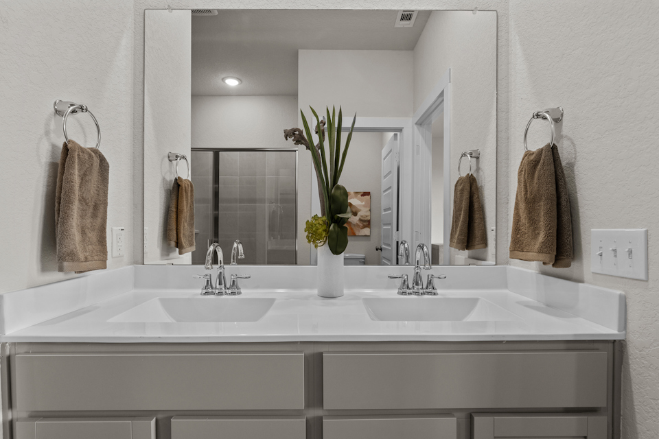 A bathroom with a large mirror.