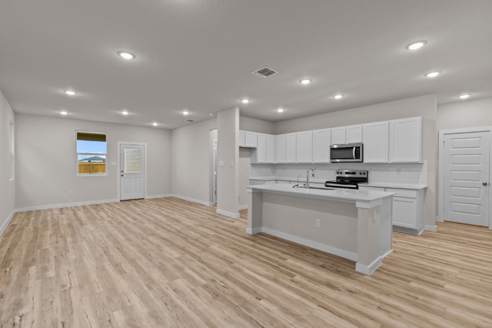 A kitchen with white cabinets.