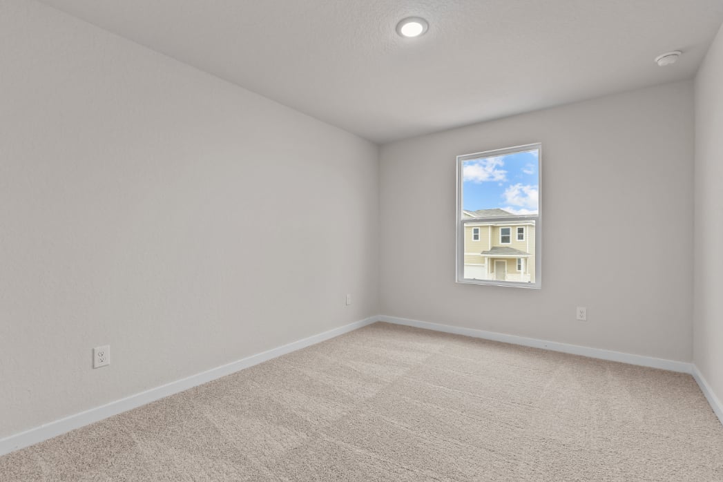 A room with a painting on the wall.