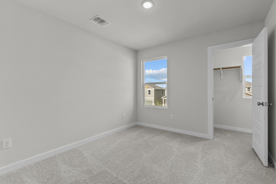 A room with a window and a door.