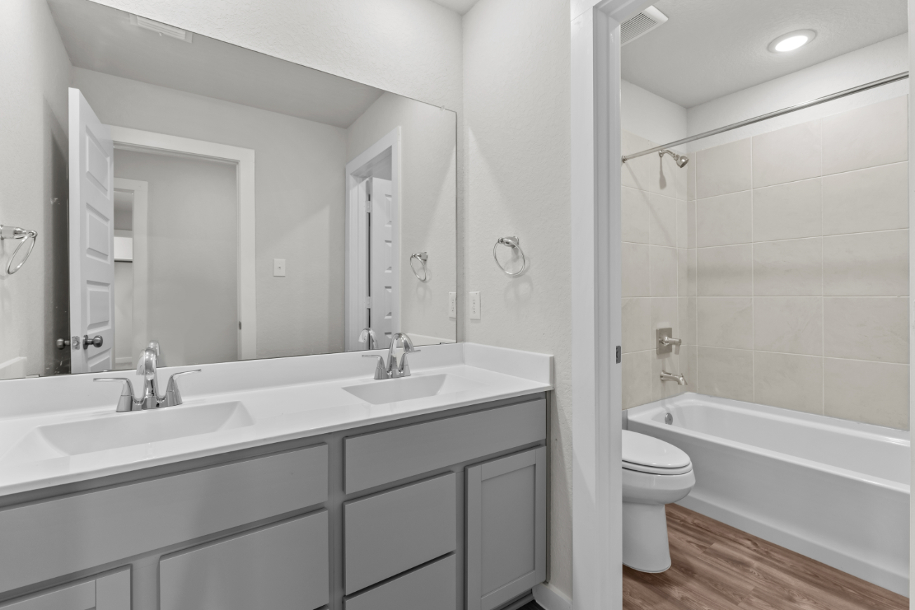 A bathroom with a tub sink and toilet.