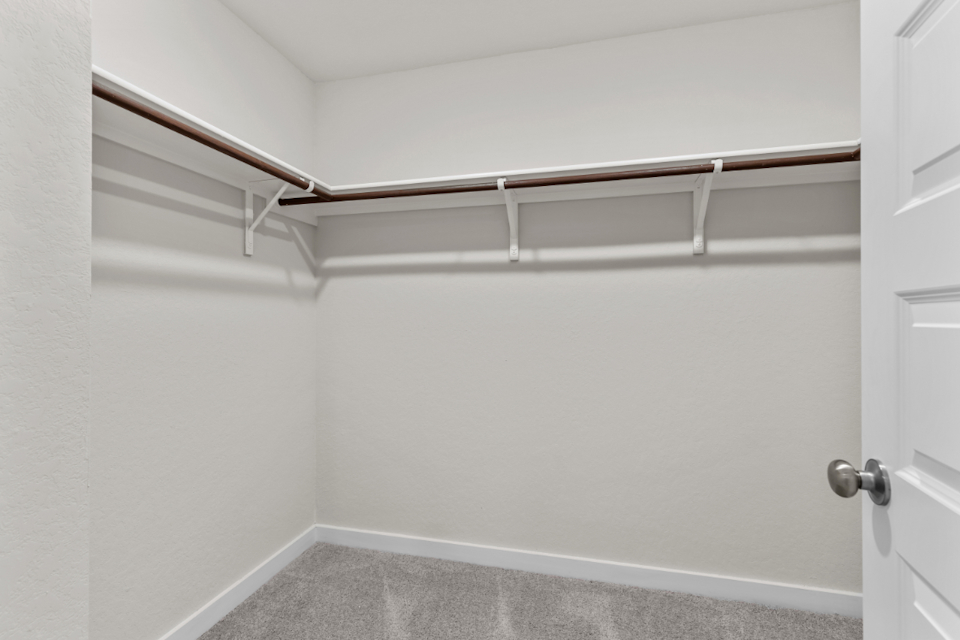 A white wall with a metal bar.