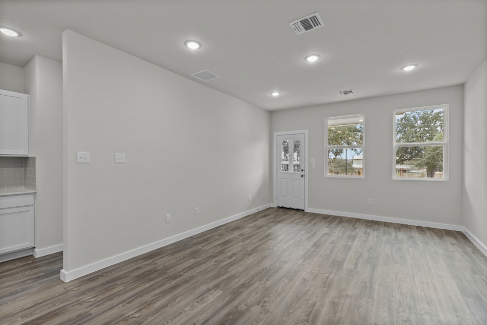 A room with a wood floor and white walls.