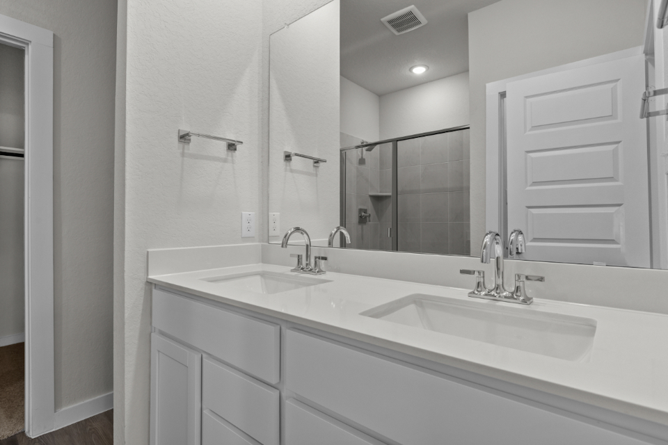 A bathroom with a large mirror.