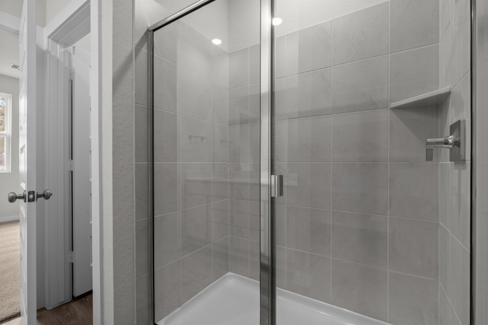 A shower with a glass door.