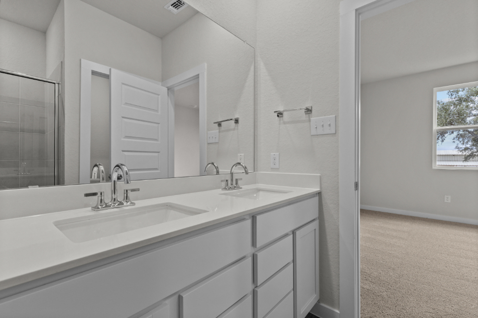 A bathroom with a large mirror.