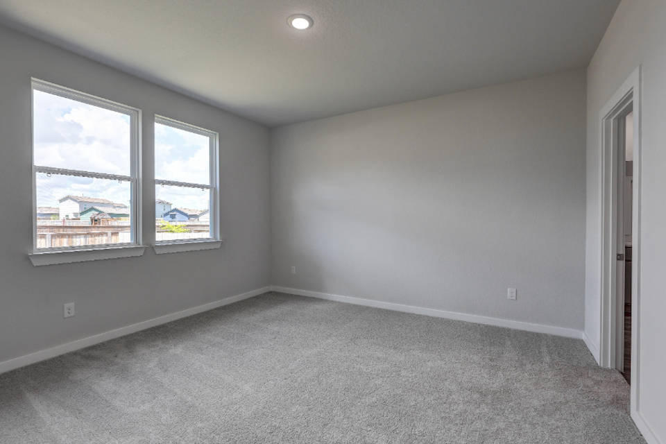 A room with a window and a carpet.