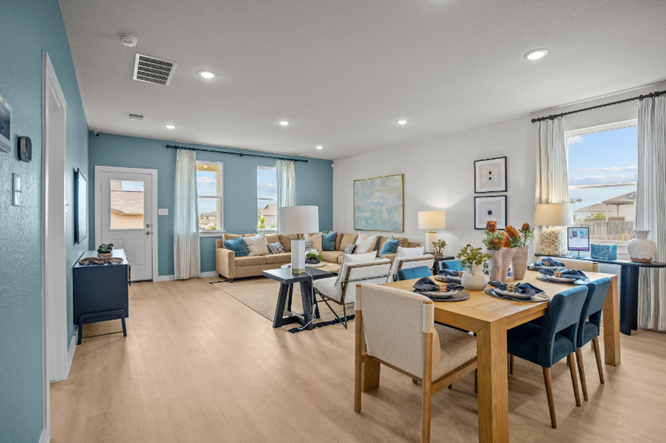 A large living room with a dining table and chairs.