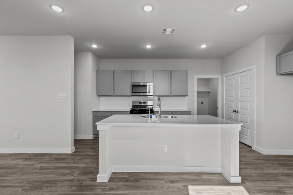 A kitchen with white cabinets.