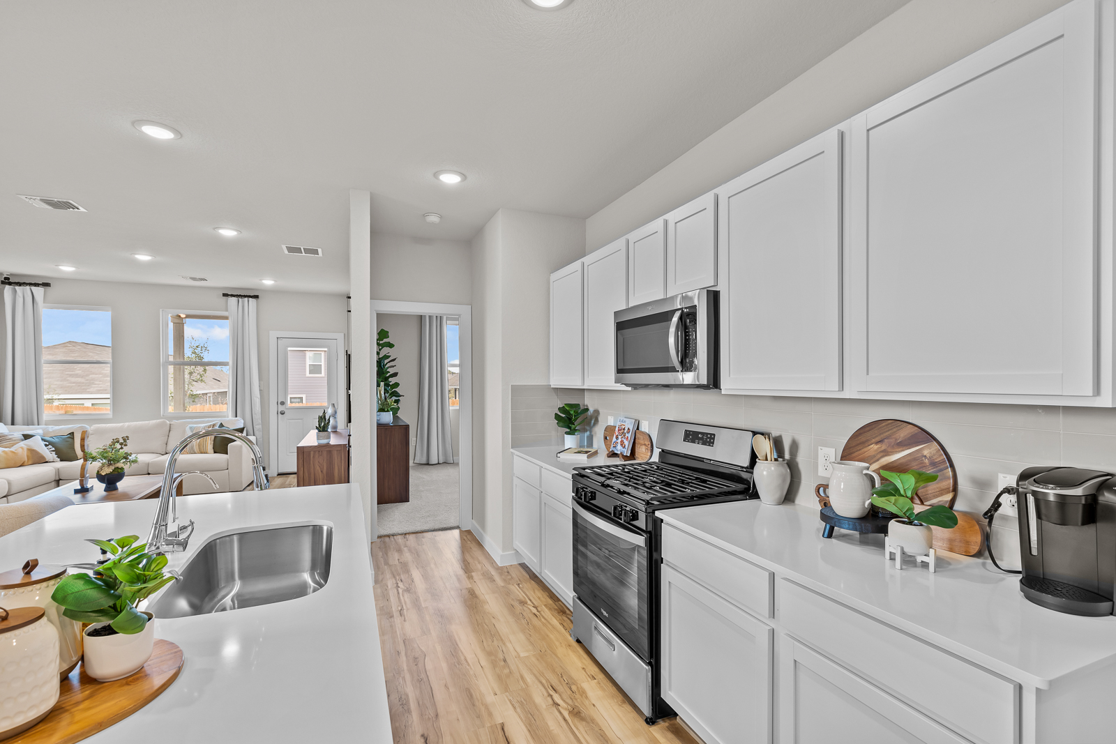 A kitchen with white cabinets.