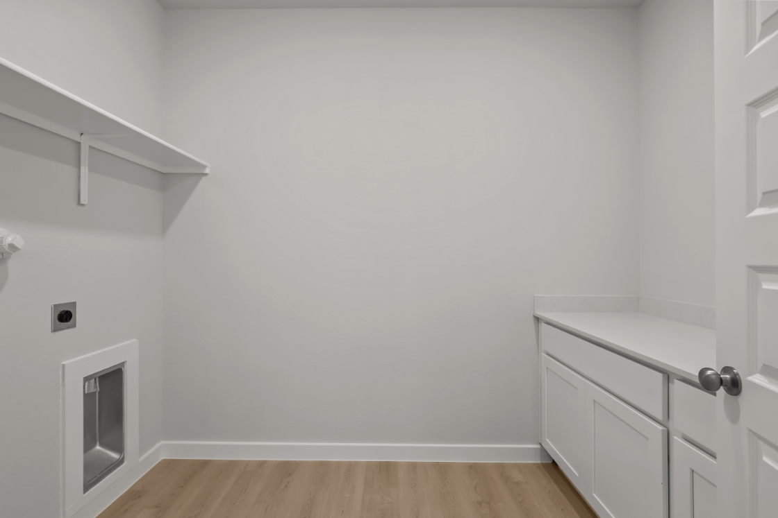 A white room with a wood floor.