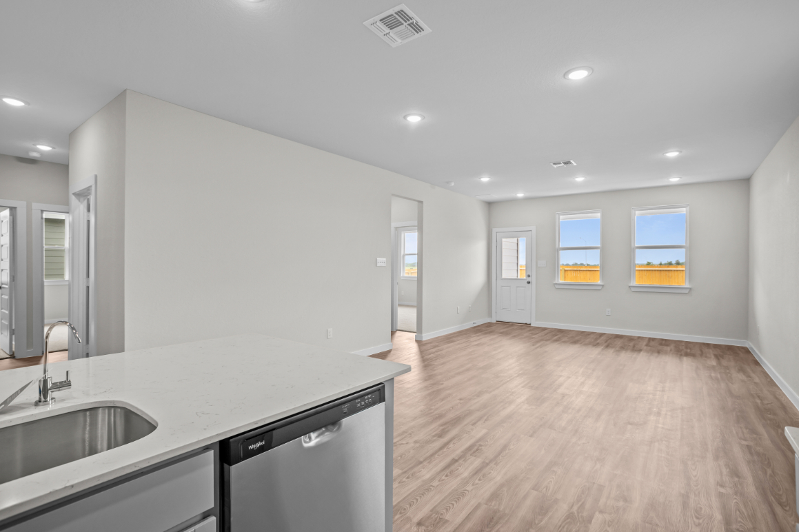 A kitchen with a wood floor.