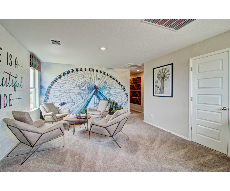 A living room with a large round window.