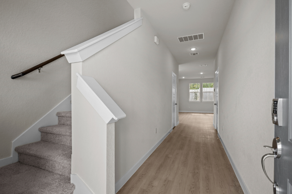 A hallway with white walls.